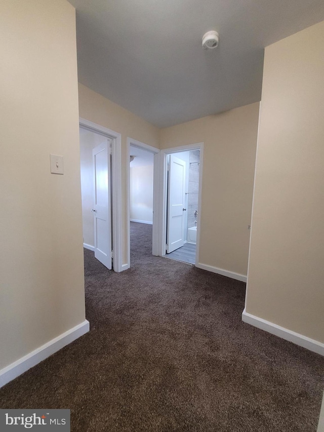 6107 Loretto Ave, Philadelphia, PA 19149 - spare room featuring dark colored carpet, a smoke detector, and baseboards