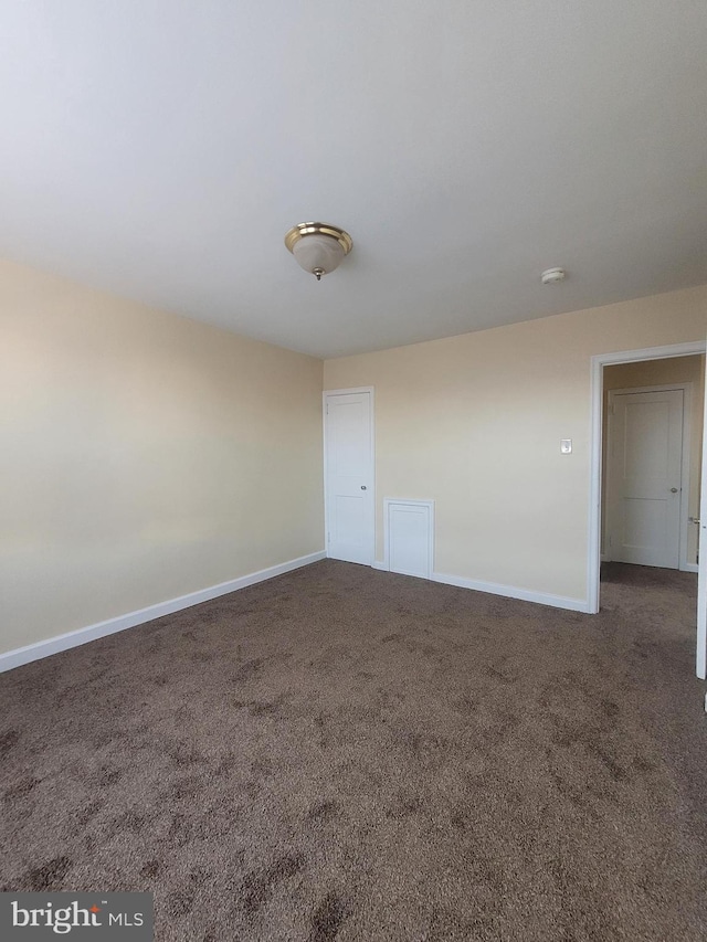 empty room with dark carpet