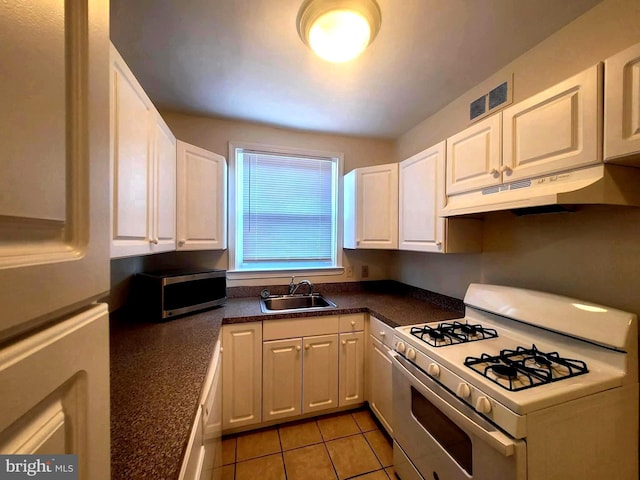 6107 Loretto Ave, Philadelphia, PA 19149 - kitchen with white gas range oven, under cabinet range hood, a sink, and white cabinets