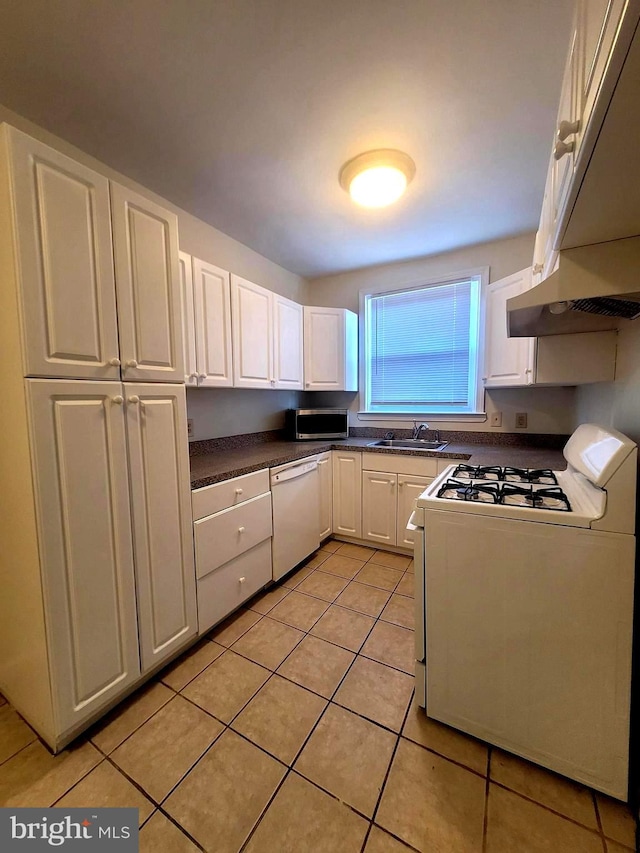 kitchen featuring light tile patterned floors, white appliances, white cabinetry, and sink