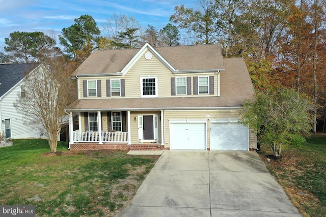 view of front of home with covered porch, a front yard, and a garage