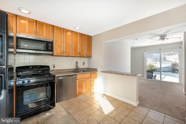 kitchen featuring ceiling fan, sink, light colored carpet, and black appliances