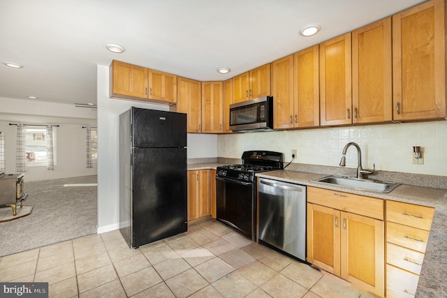 kitchen featuring black appliances, sink, and light carpet