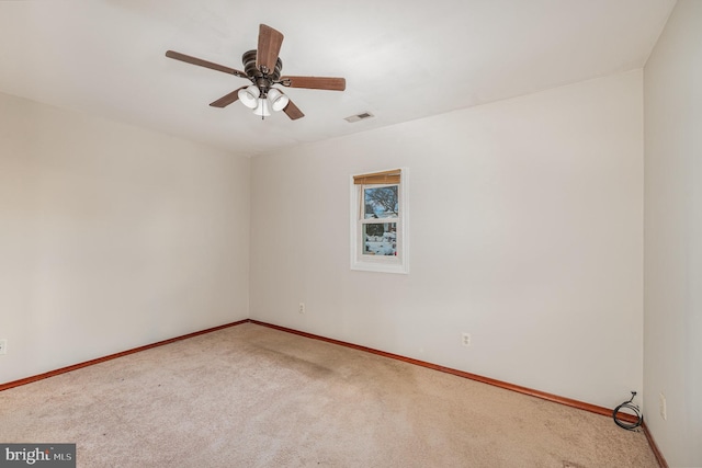 spare room with carpet floors and ceiling fan