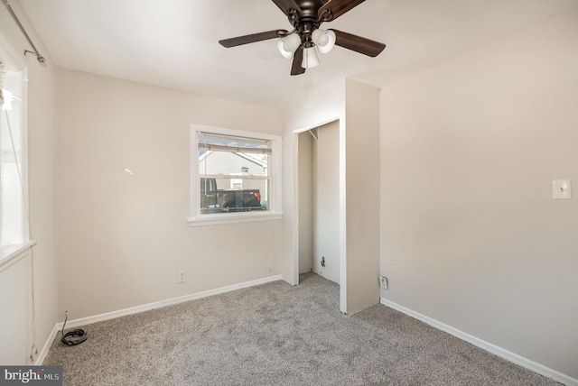 carpeted empty room with ceiling fan