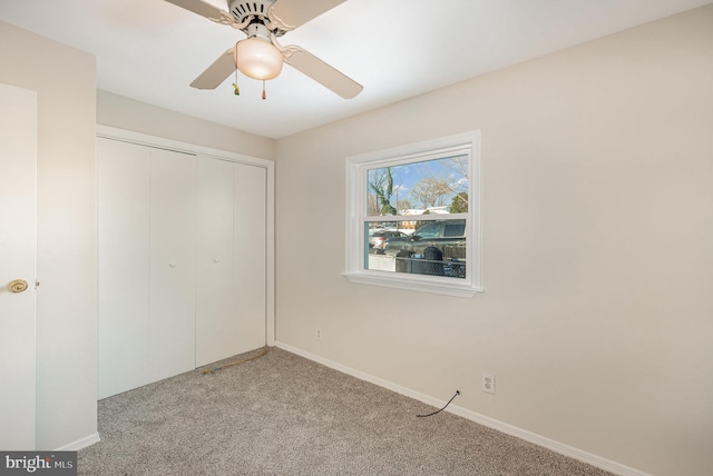 unfurnished bedroom featuring a closet, ceiling fan, and light colored carpet