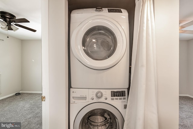 clothes washing area featuring carpet floors, stacked washer / dryer, and ceiling fan