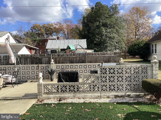 view of gate featuring a patio area