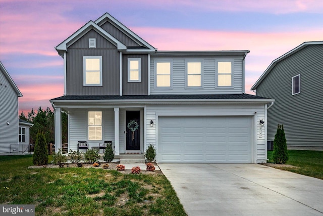 view of front of home with a lawn and a garage