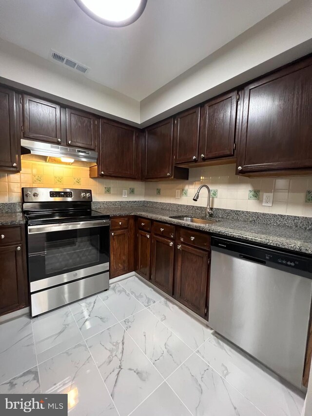 kitchen with sink, dark brown cabinetry, backsplash, and appliances with stainless steel finishes