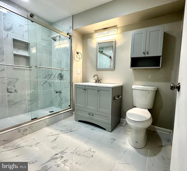 bathroom featuring vanity, toilet, and a shower with shower door