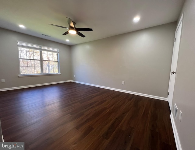 unfurnished room featuring ceiling fan and dark wood-type flooring