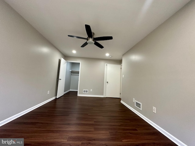 unfurnished bedroom featuring a closet, ceiling fan, and dark wood-type flooring