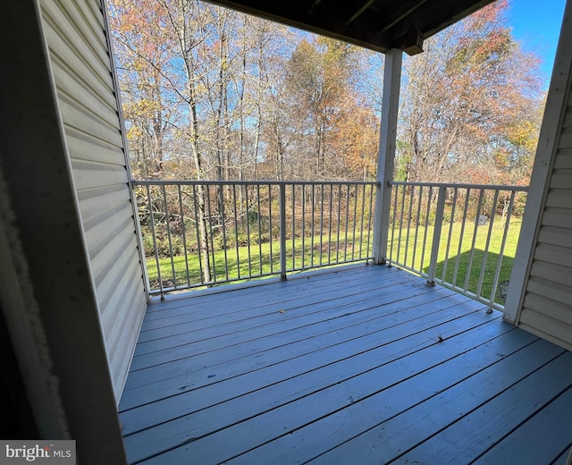 wooden deck featuring a yard