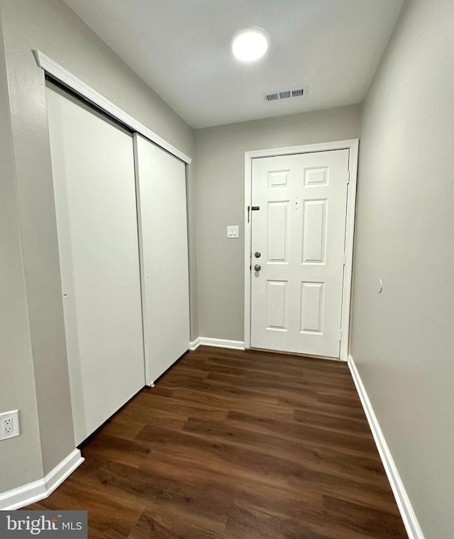 doorway with dark hardwood / wood-style floors