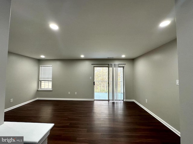 spare room featuring dark wood-type flooring