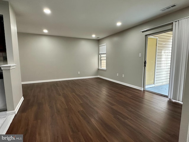 spare room with dark wood-type flooring