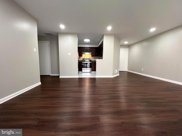 unfurnished living room featuring dark wood-type flooring