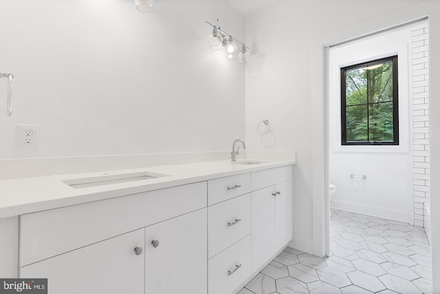 bathroom featuring tile patterned floors, vanity, and toilet