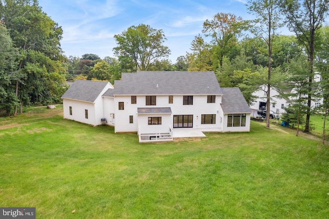 back of house featuring a lawn and a patio area