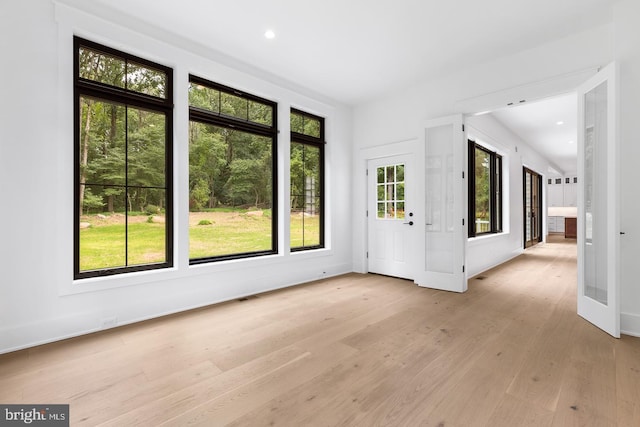 interior space with french doors and light hardwood / wood-style floors