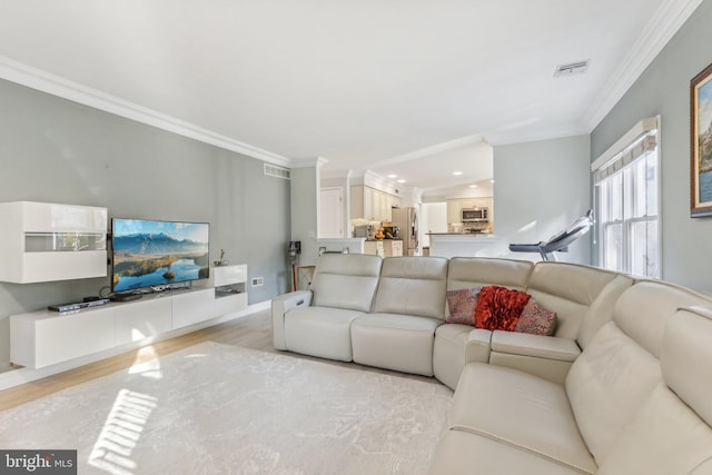 living room with ornamental molding and light wood-type flooring