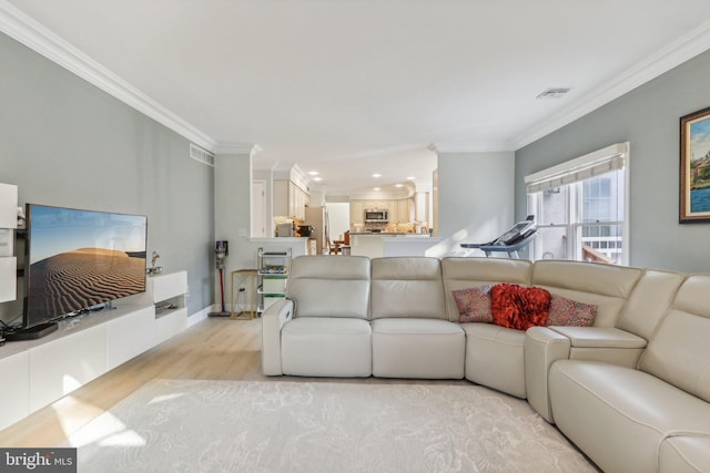 living room featuring light hardwood / wood-style floors and ornamental molding