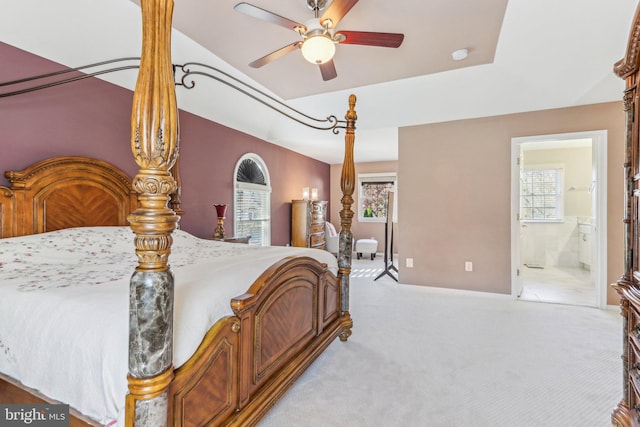 carpeted bedroom featuring ensuite bathroom and ceiling fan