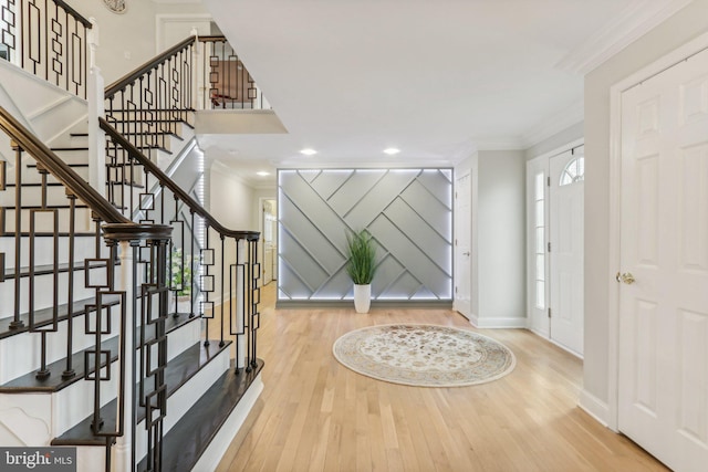 entryway featuring hardwood / wood-style floors and crown molding