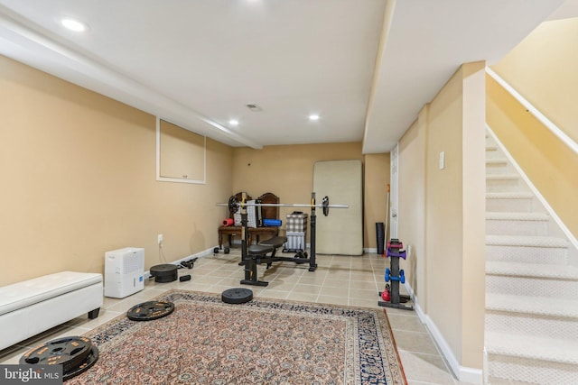 exercise room with light tile patterned floors