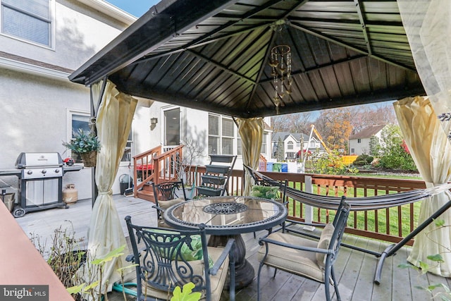 wooden deck featuring a gazebo and area for grilling