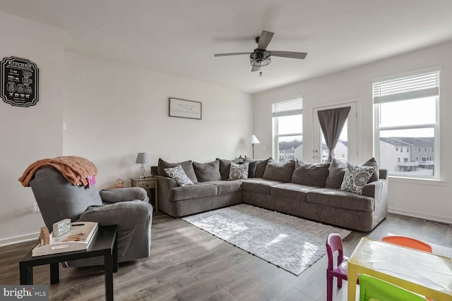 living room with hardwood / wood-style flooring and ceiling fan