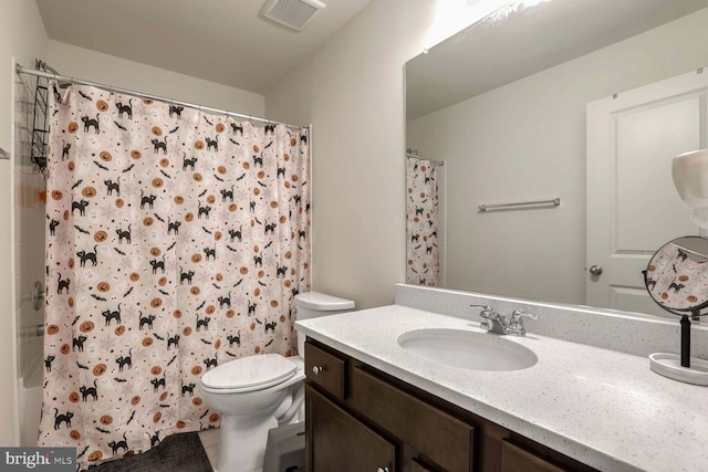 bathroom with vanity, toilet, and curtained shower