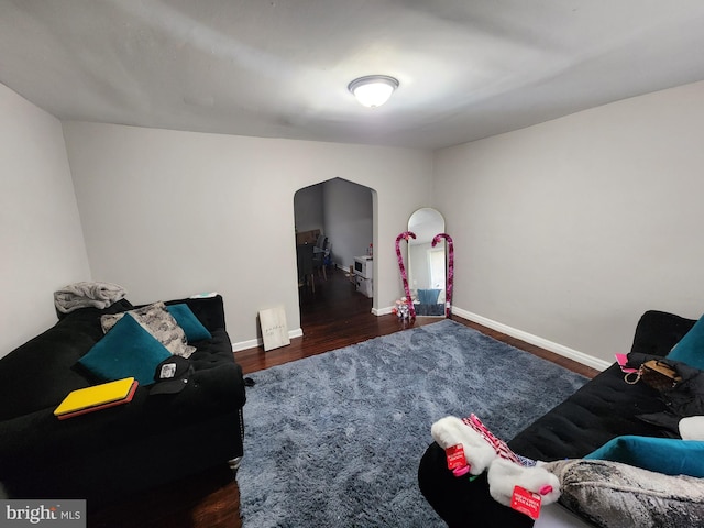 interior space with dark hardwood / wood-style flooring and lofted ceiling