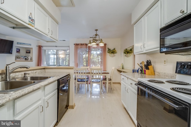 kitchen with black appliances, sink, light stone countertops, light hardwood / wood-style floors, and white cabinetry