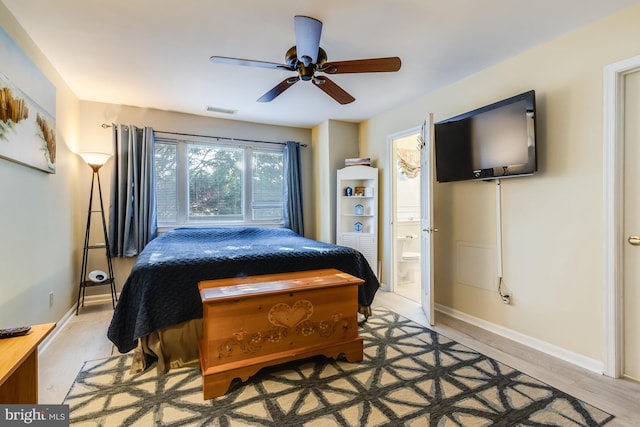 bedroom featuring ensuite bath, ceiling fan, and light wood-type flooring