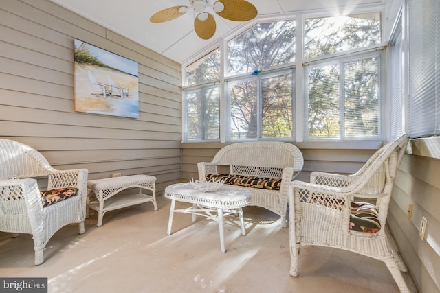 sunroom / solarium featuring a wealth of natural light, lofted ceiling, and ceiling fan