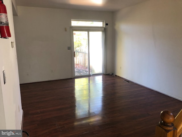 unfurnished room featuring dark hardwood / wood-style floors