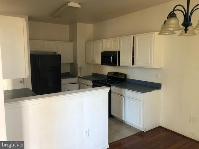 kitchen with white cabinetry, hanging light fixtures, dark hardwood / wood-style flooring, kitchen peninsula, and black appliances