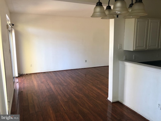 interior space featuring a chandelier and dark hardwood / wood-style floors