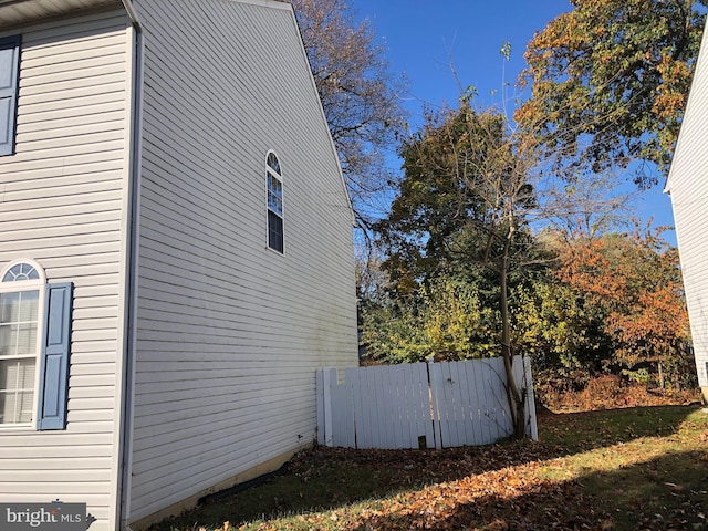 view of property exterior with a lawn