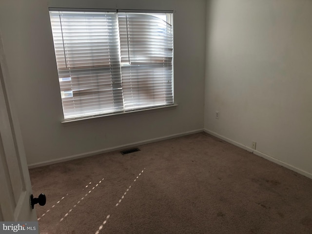 spare room featuring carpet