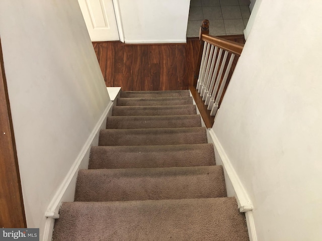 stairs with hardwood / wood-style floors