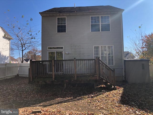 back of property featuring a wooden deck