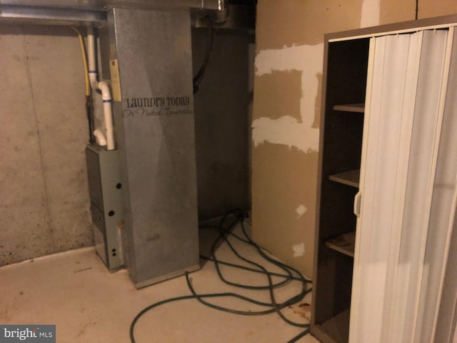 utility room featuring heating unit