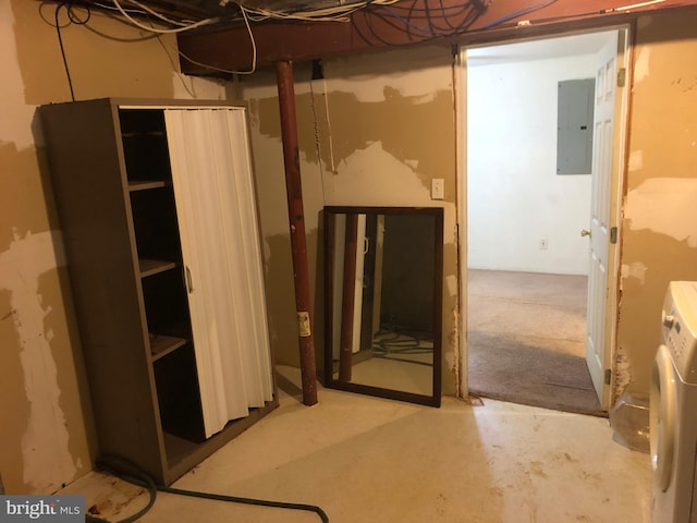 basement with electric panel and washer / clothes dryer