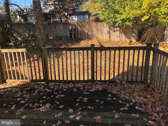 view of gate with a wooden deck