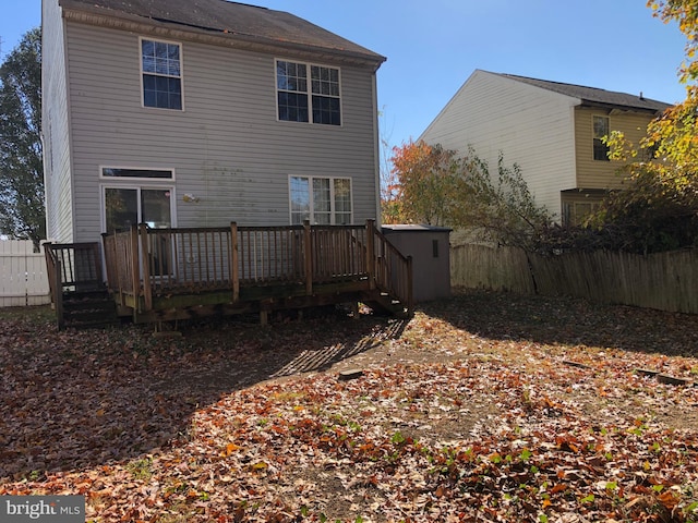 back of property with a wooden deck