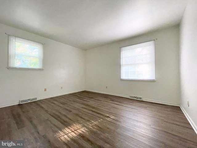 spare room with dark wood-type flooring