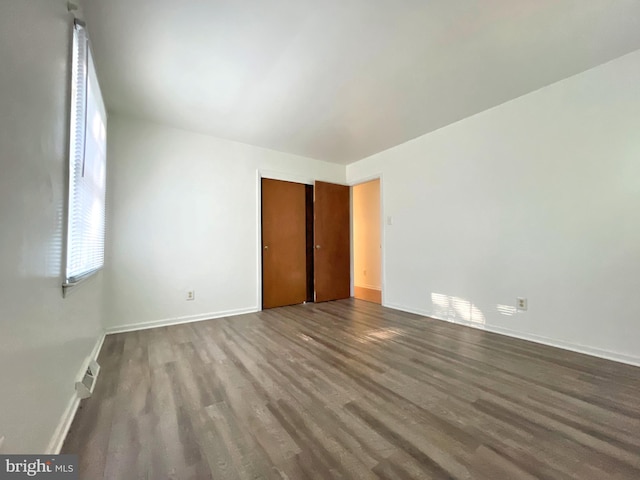 unfurnished bedroom featuring hardwood / wood-style flooring